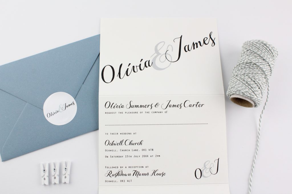 A wedding invitation in a concertina style with a calligraphy style font.